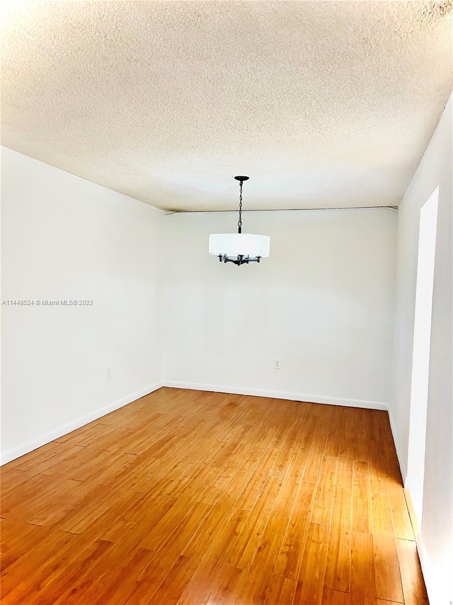 6801 Southwest 147th Avenue, Unit 1E2 Miami, FL 33193 - Photo 2 of 15 a view of empty room with wooden floor