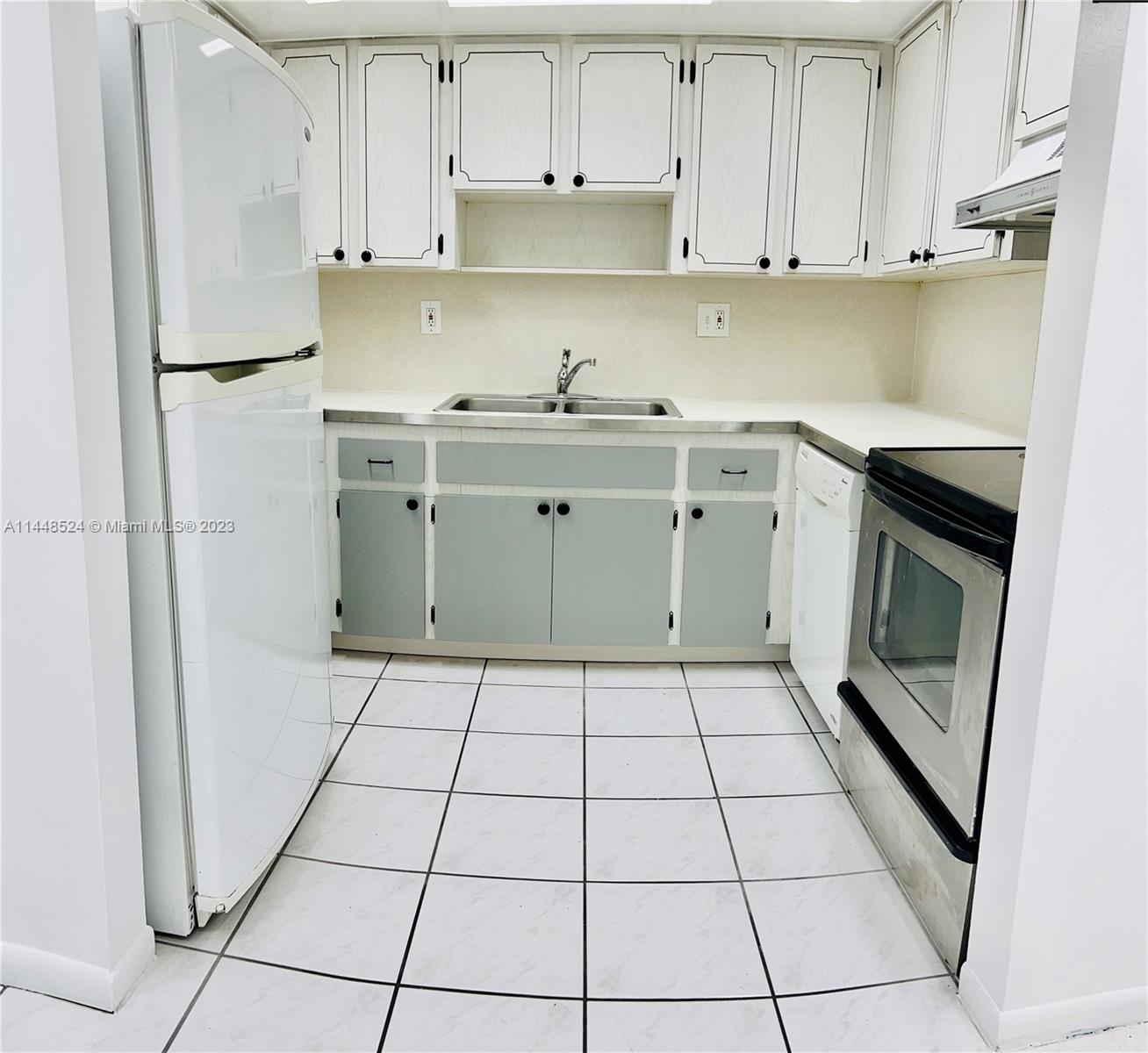 6801 Southwest 147th Avenue, Unit 1E2 Miami, FL 33193 - Photo 3 of 15 a kitchen with a sink a stove and refrigerator