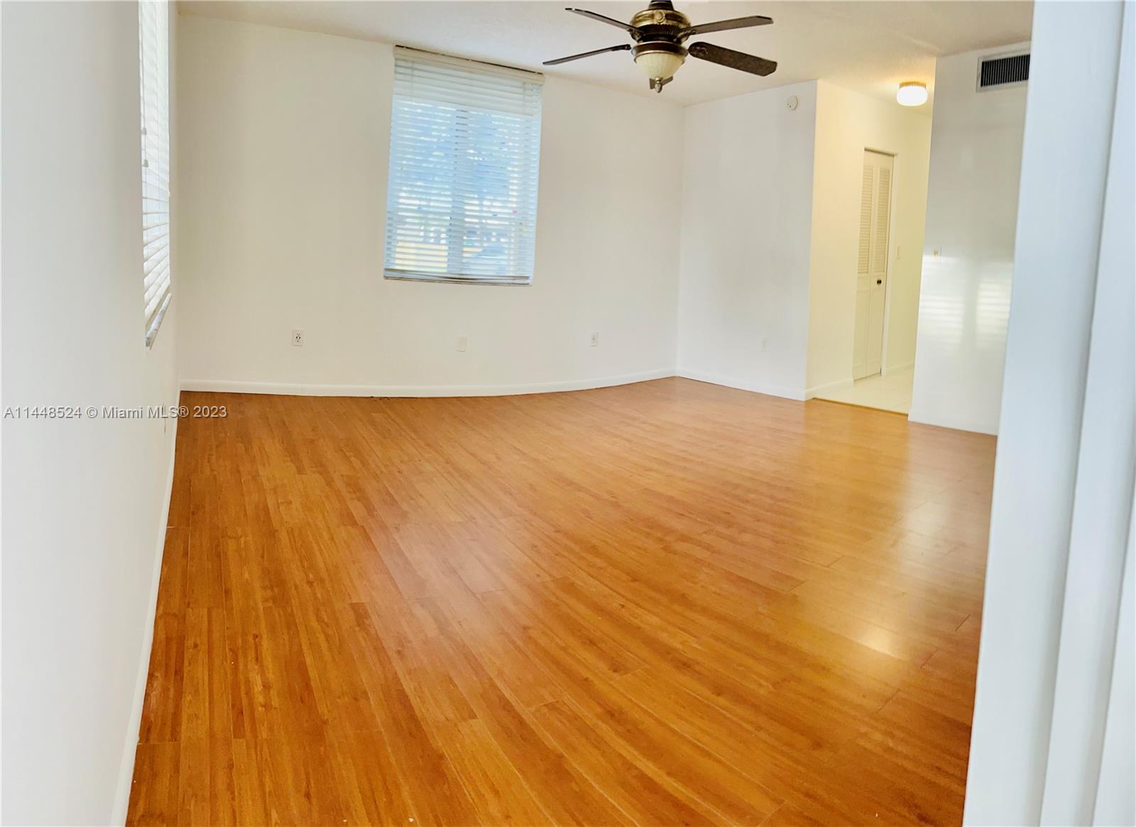 6801 Southwest 147th Avenue, Unit 1E2 Miami, FL 33193 - Photo 5 of 15 a view of a room with wooden floor and cabinet