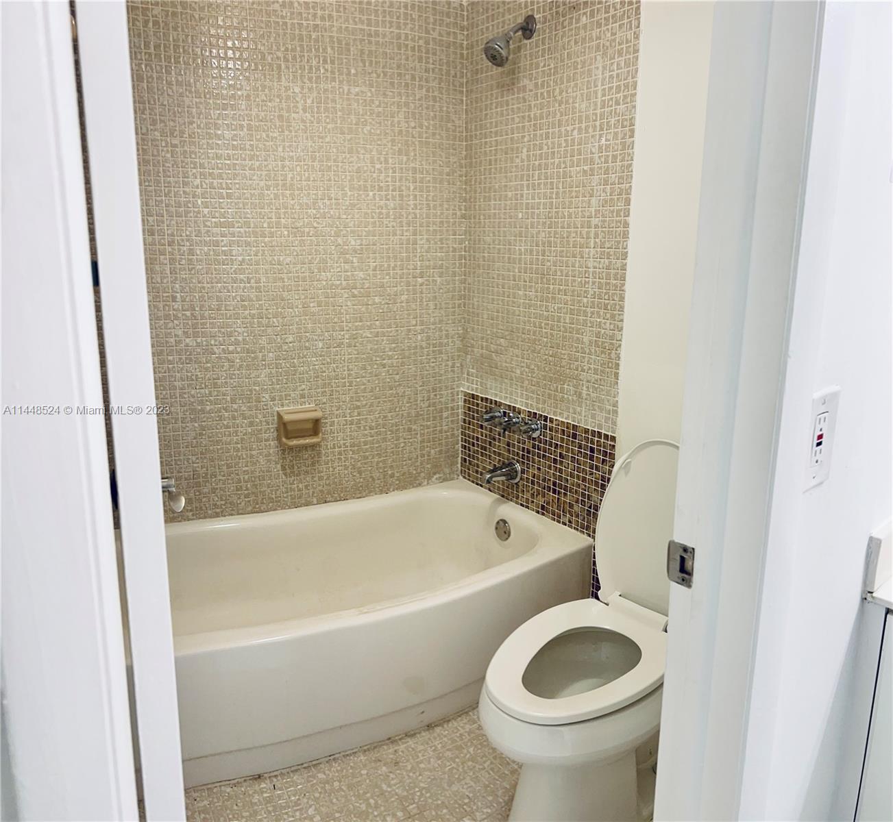 6801 Southwest 147th Avenue, Unit 1E2 Miami, FL 33193 - Photo 6 of 15 a bathroom with a toilet and a bathtub