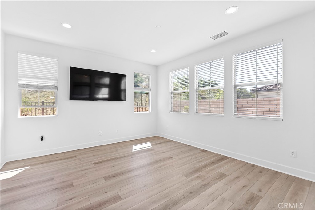 5024 Rexton Drive Camarillo, CA 93012 - Photo 13 of 48 a view of a livingroom with wooden floor and windows