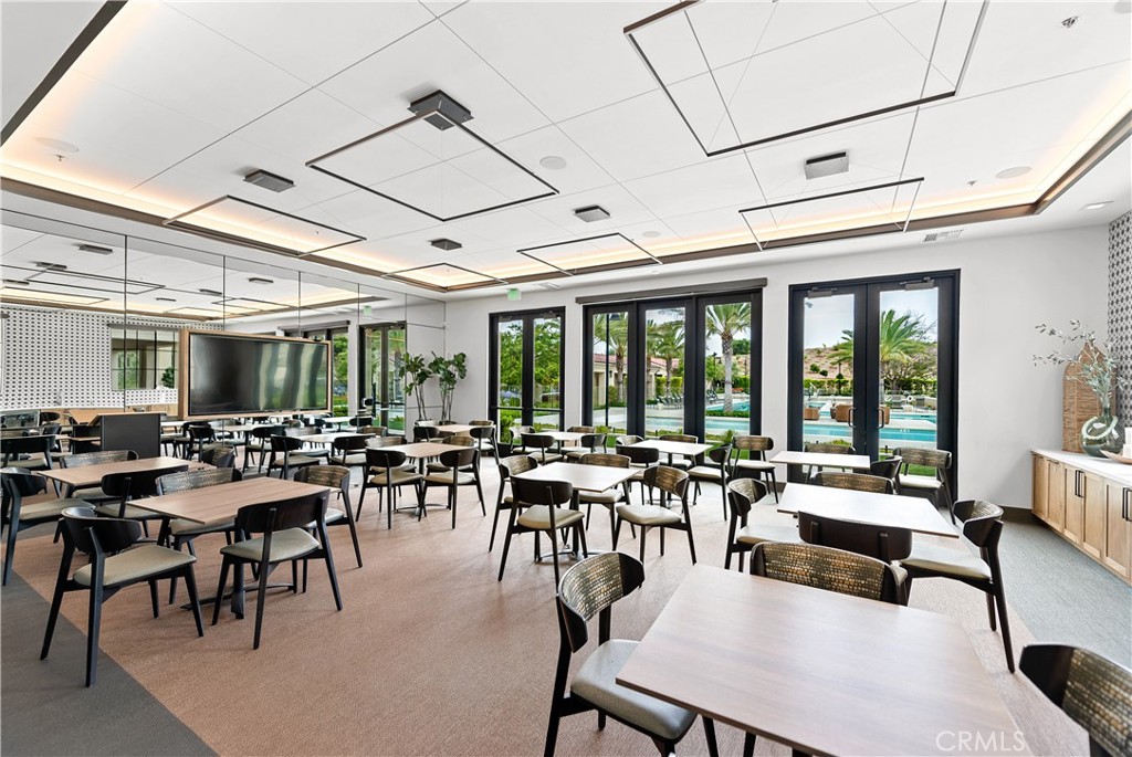 5024 Rexton Drive Camarillo, CA 93012 - Photo 48 of 48 a room with lots of tables a large window and chairs