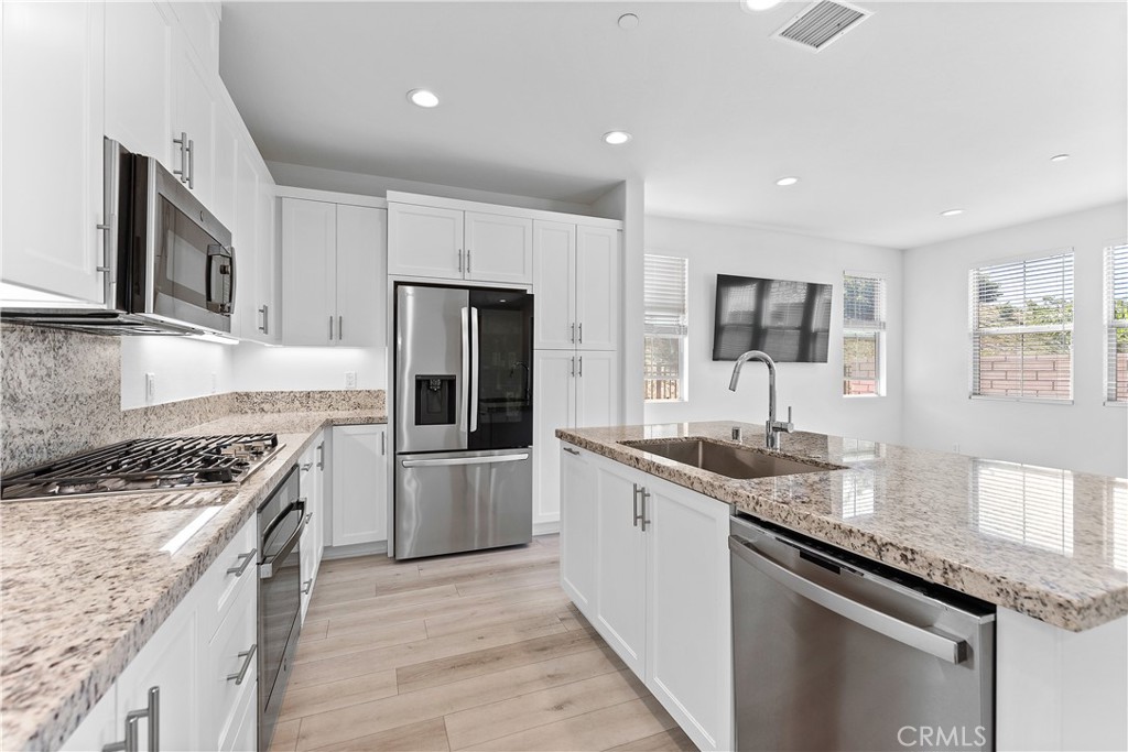 5024 Rexton Drive Camarillo, CA 93012 - Photo 8 of 48 a kitchen with a sink stove and refrigerator