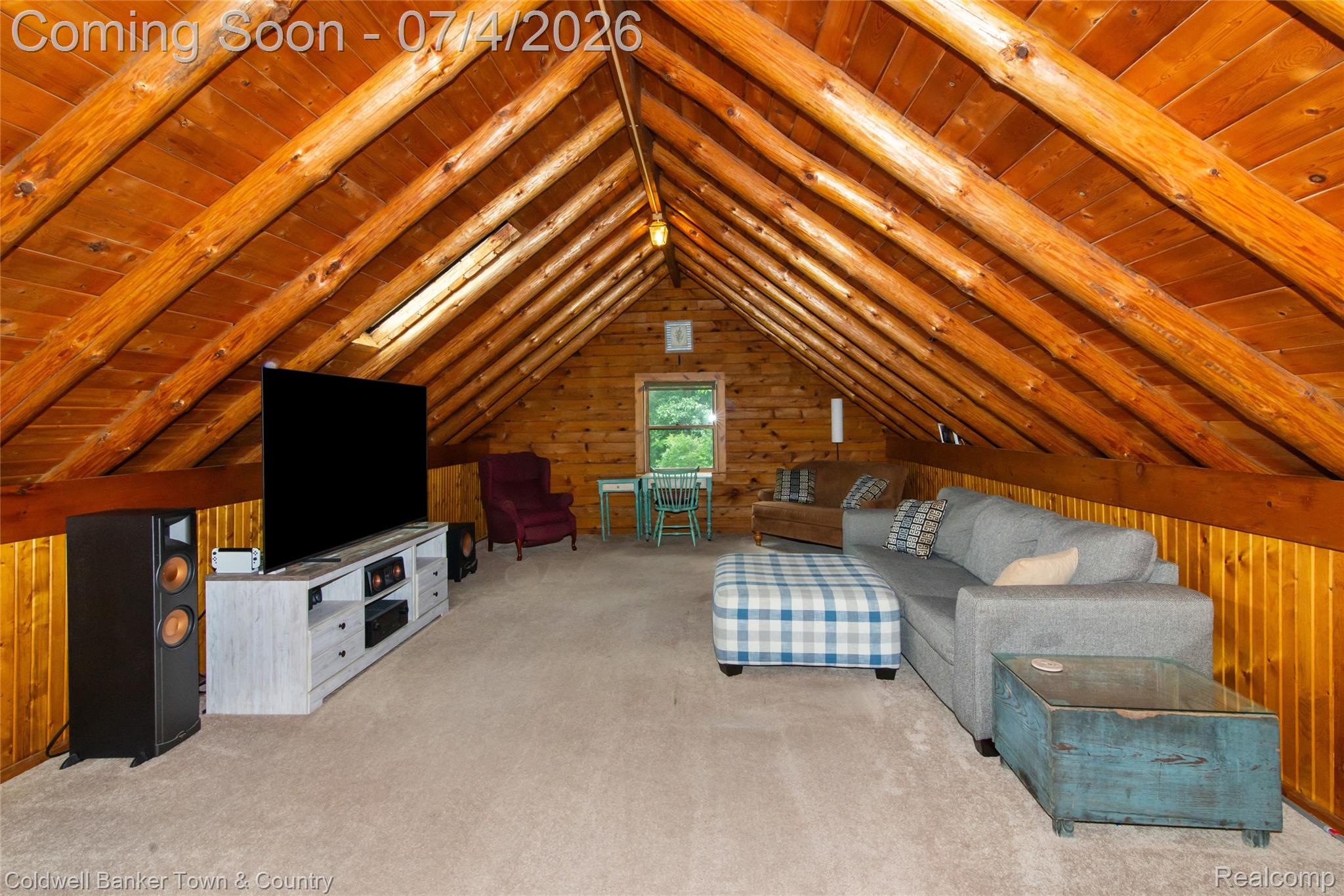7335 Richardson Road Howell, MI 48843 - Photo 41 of 54 Open loft space with exposed wood beams and wood-paneled walls