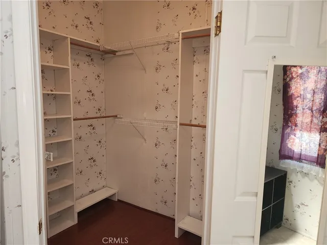 a view of walk in closet with empty racks