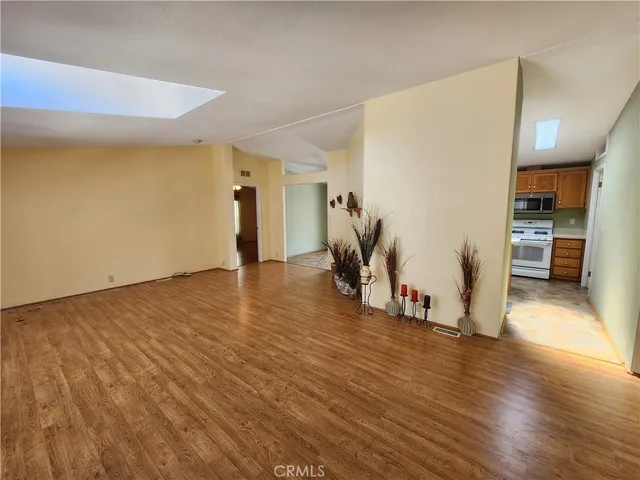 a view of a room with wooden floor