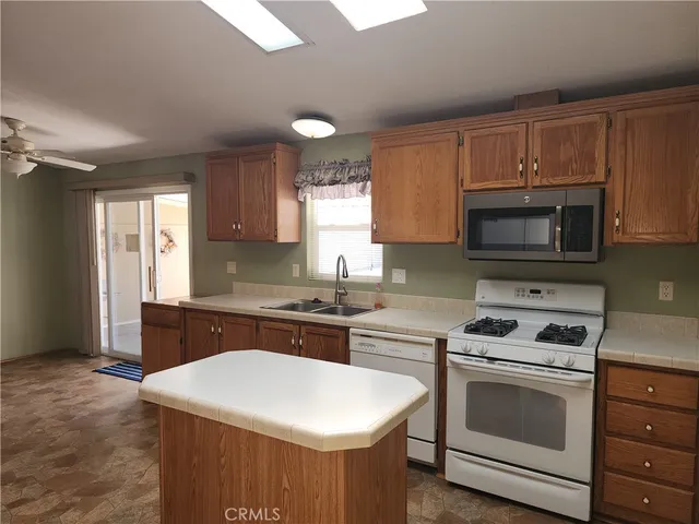 a kitchen with a stove a sink and a microwave