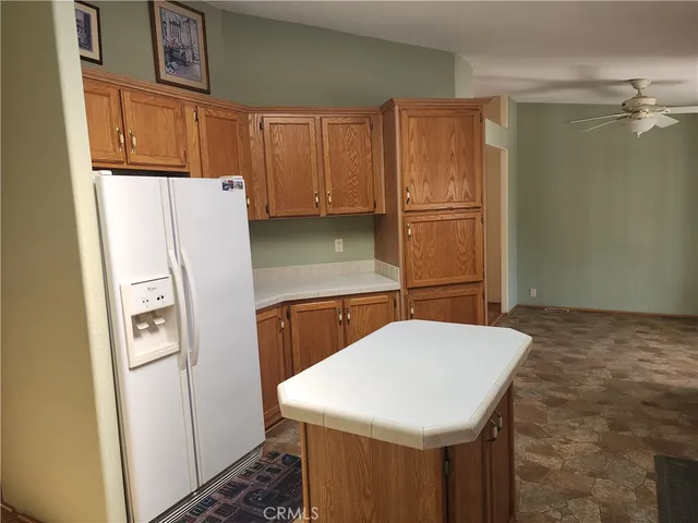 a kitchen with stainless steel appliances a refrigerator and microwave