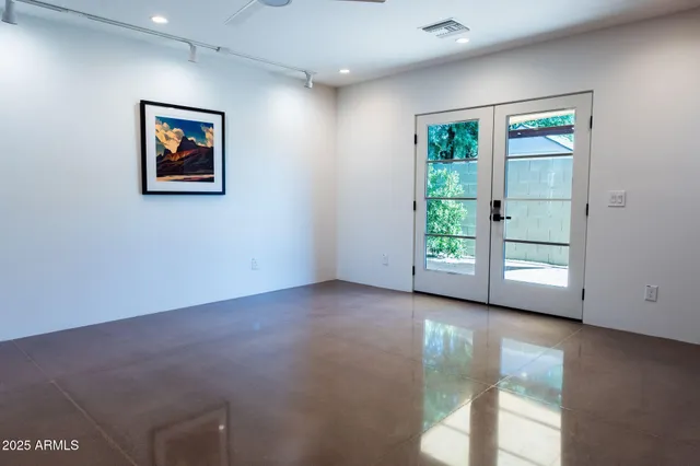 an empty room with windows and closet