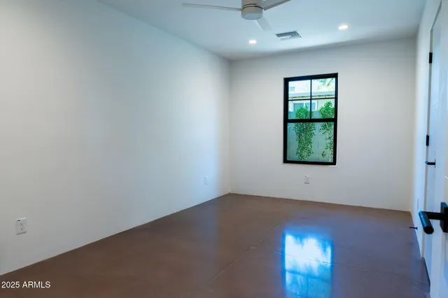 an empty room with a empty space and windows