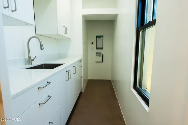 a kitchen with white cabinets