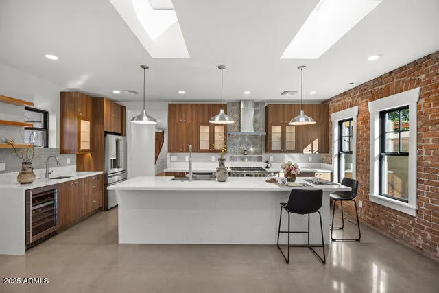 a kitchen with stainless steel appliances kitchen island granite countertop a sink and a stove
