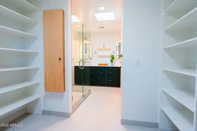 a bathroom with a mirror and a shower
