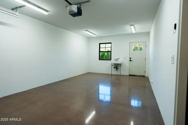 an empty room with entrance and windows
