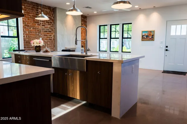 a kitchen with a sink cabinets and window