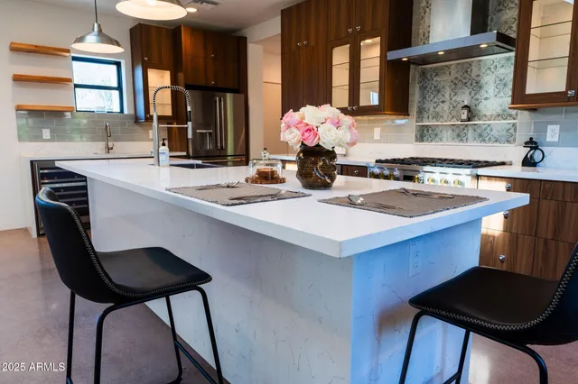a kitchen with a table chairs sink and cabinets