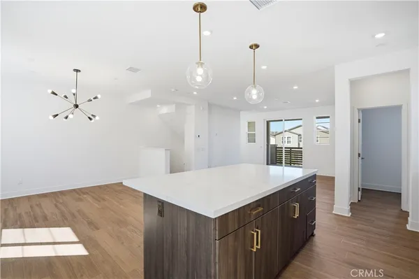 a view of kitchen dining table wooden floor and kitchen