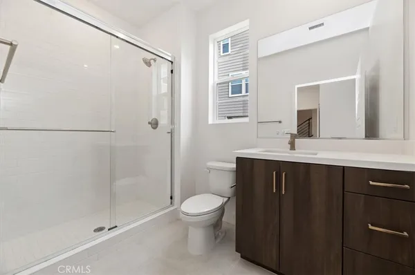 a bathroom with a double vanity sink toilet and shower