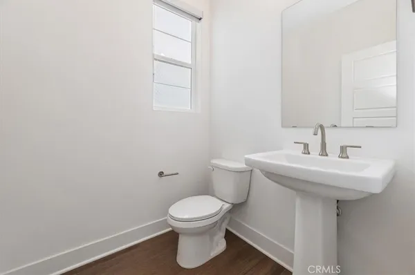 a bathroom with a sink toilet and a mirror