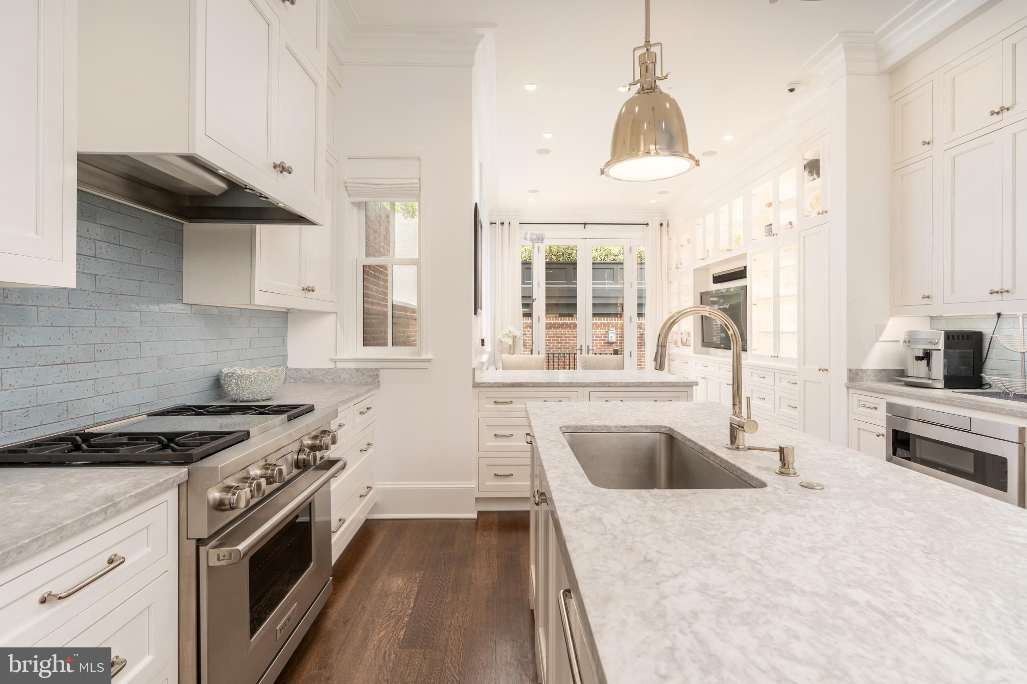 1619 19th Street Northwest Washington, DC 20009 - Photo 12 of 50 a kitchen with stainless steel appliances granite countertop a sink stove and refrigerator