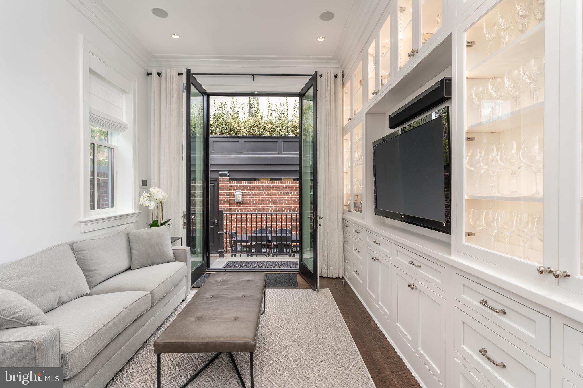 1619 19th Street Northwest Washington, DC 20009 - Photo 16 of 50 a living room with furniture and a flat screen tv