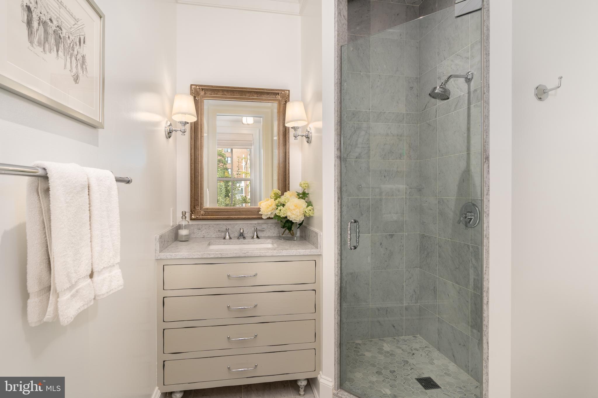 1619 19th Street Northwest Washington, DC 20009 - Photo 29 of 50 a bathroom with a shower sink and mirror