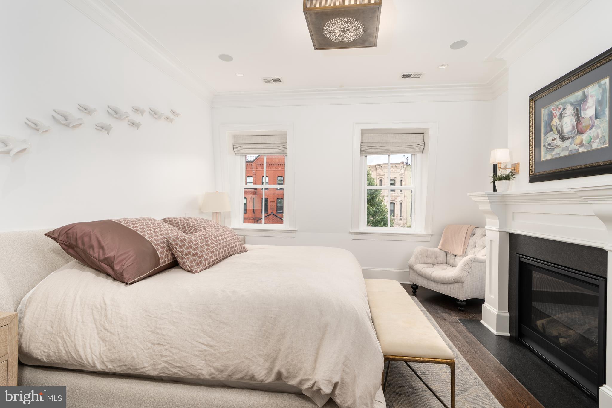 1619 19th Street Northwest Washington, DC 20009 - Photo 35 of 50 a bedroom with a bed fireplace and window