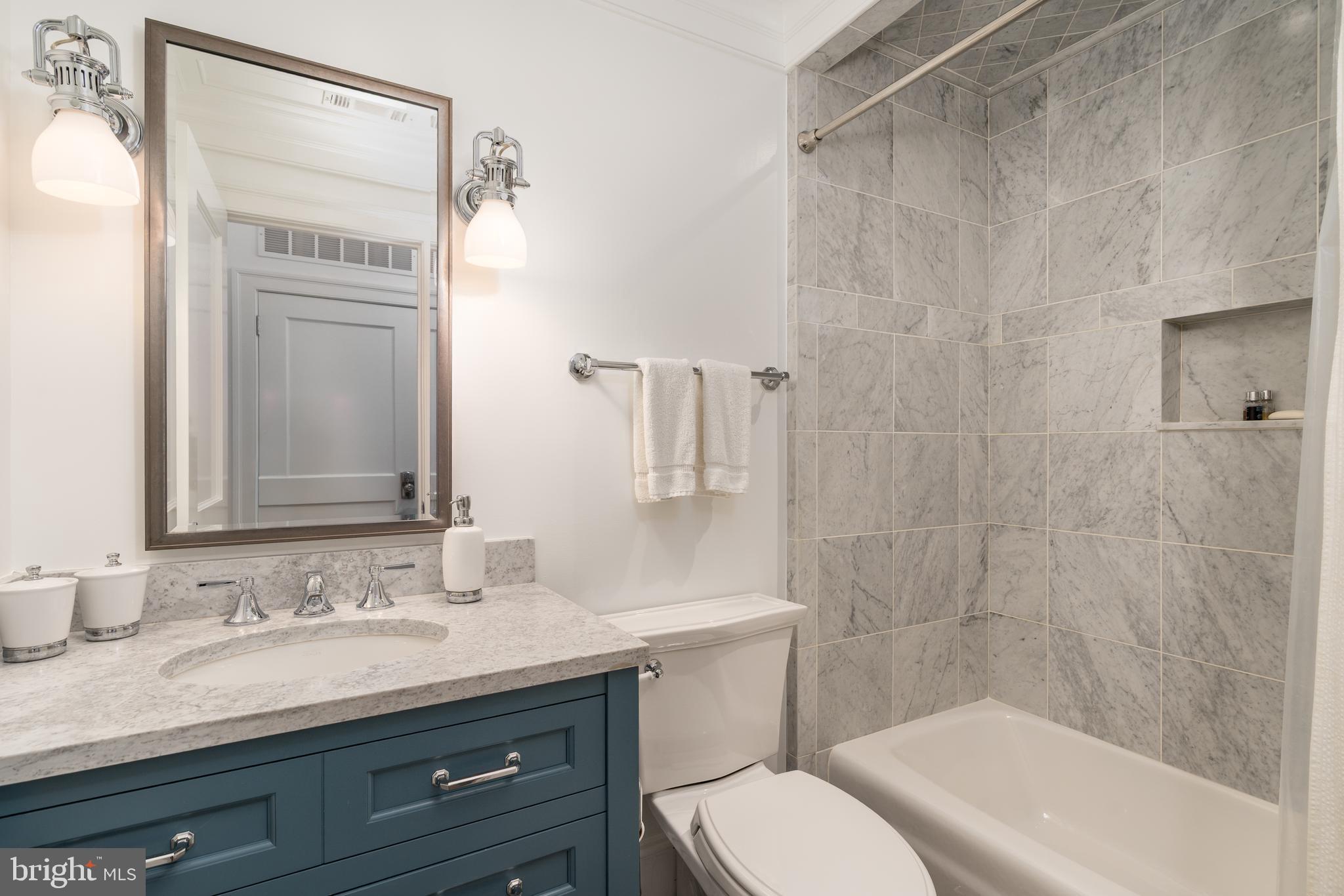 1619 19th Street Northwest Washington, DC 20009 - Photo 46 of 50 a bathroom with a granite countertop sink toilet and shower