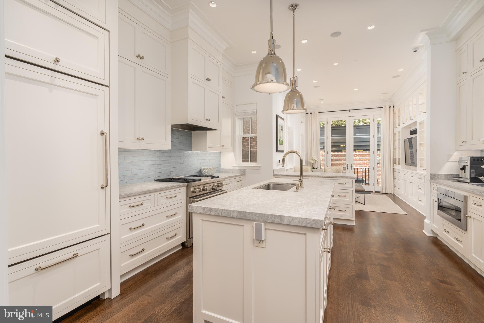 1619 19th Street Northwest Washington, DC 20009 - Photo 10 of 50 a kitchen with stainless steel appliances a stove a sink a center island and cabinets