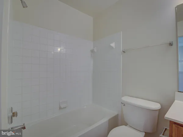 a white toilet sitting next to a bath tub