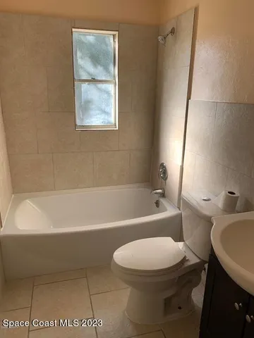 a bathroom with a toilet a sink and bathtub