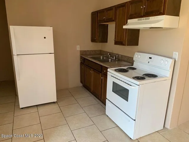 a kitchen with a stove and a refrigerator