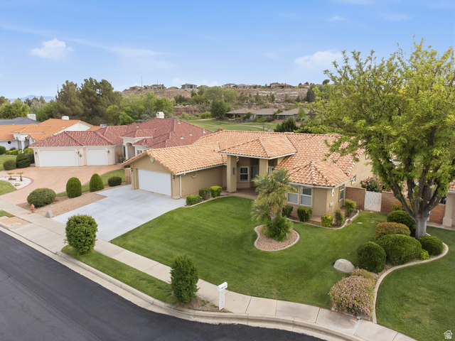 1985 West Rivers Edge Lane St. George, UT 84770 - Photo 3 of 42 Mediterranean / spanish home with driveway, stucco siding, a garage, a tile roof, and a residential view