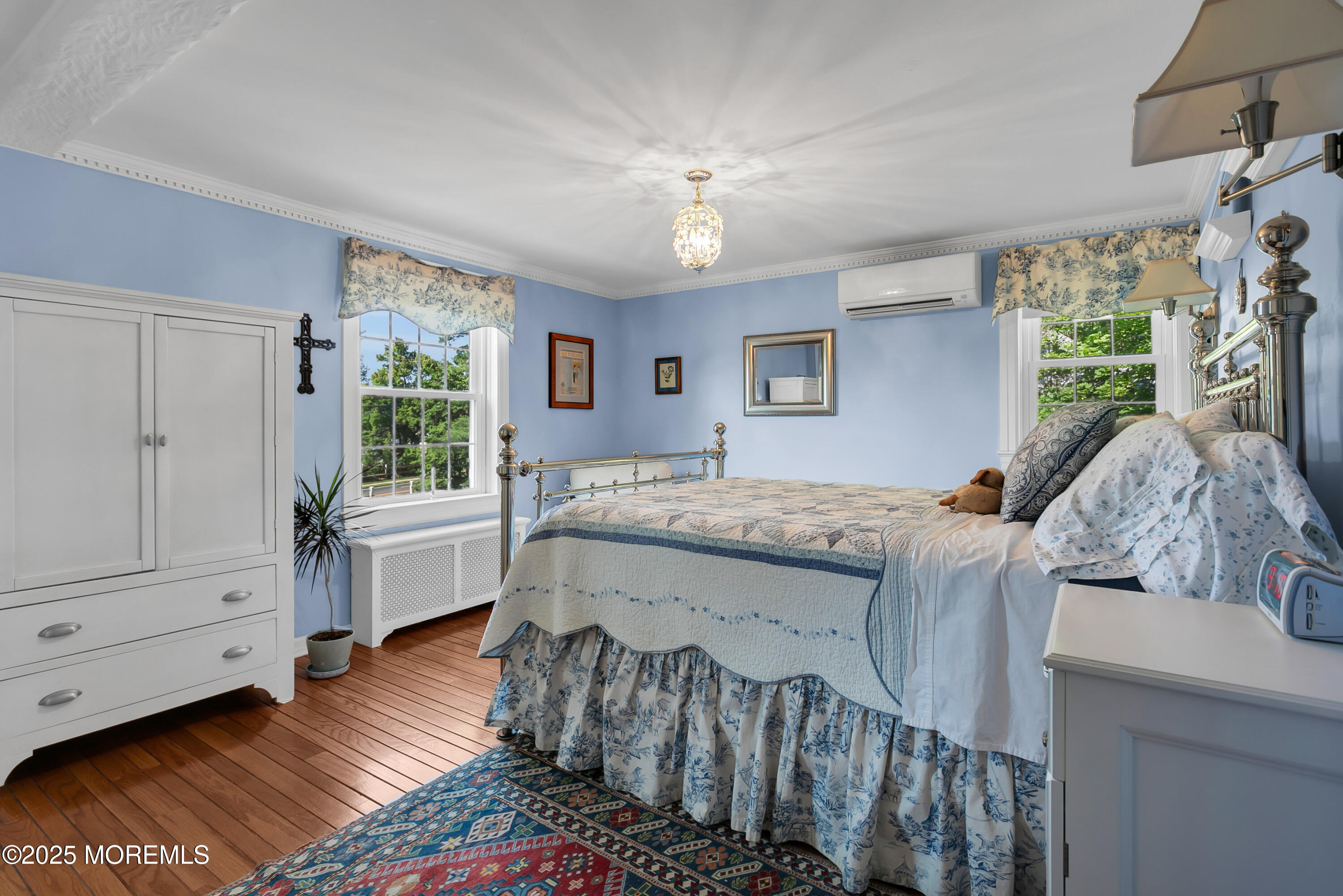 263 Cooper Road Red Bank, NJ 07701 - Photo 18 of 42 a bedroom with a bed and a chandelier