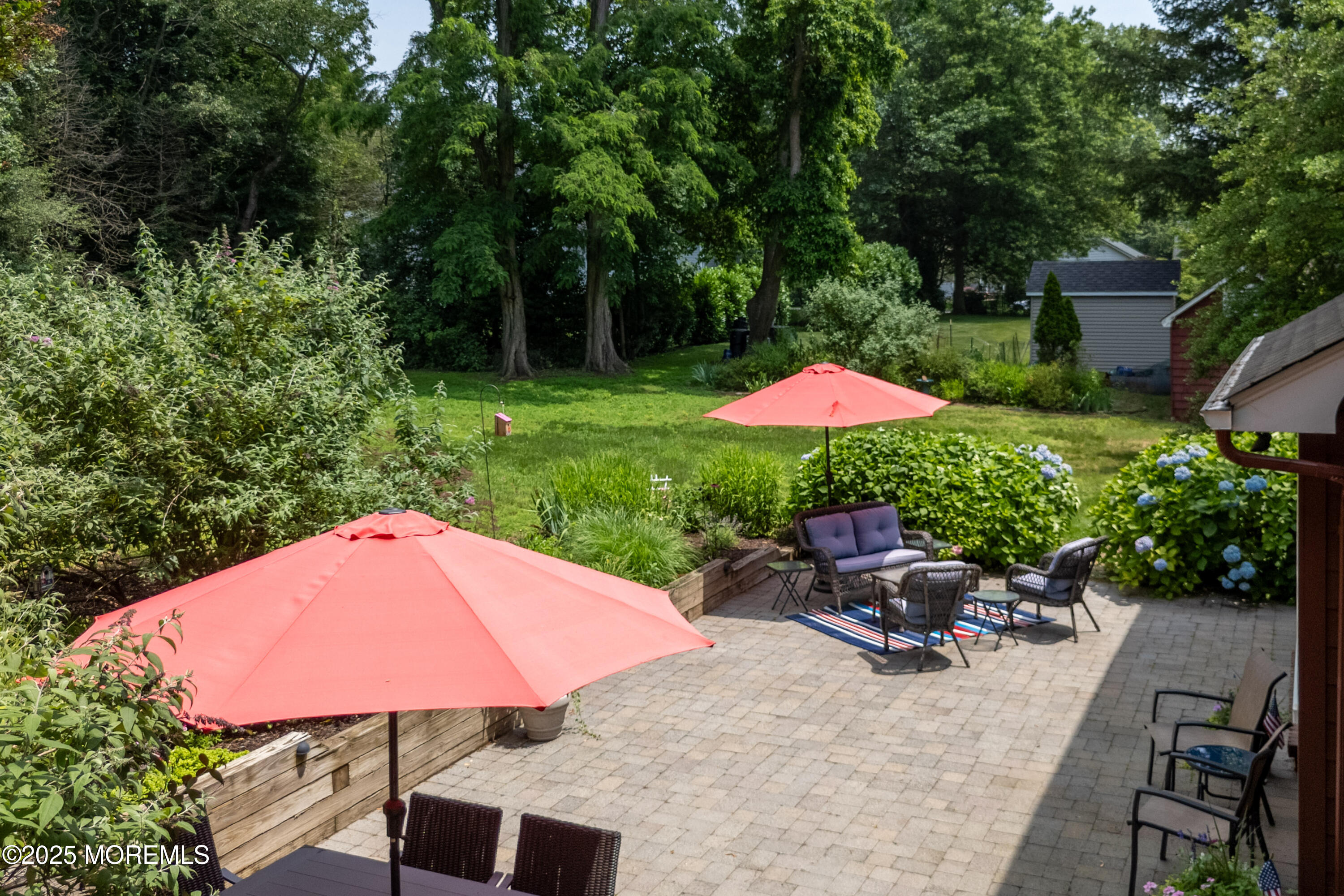 263 Cooper Road Red Bank, NJ 07701 - Photo 31 of 42 an outdoor space with furniture and umbrella