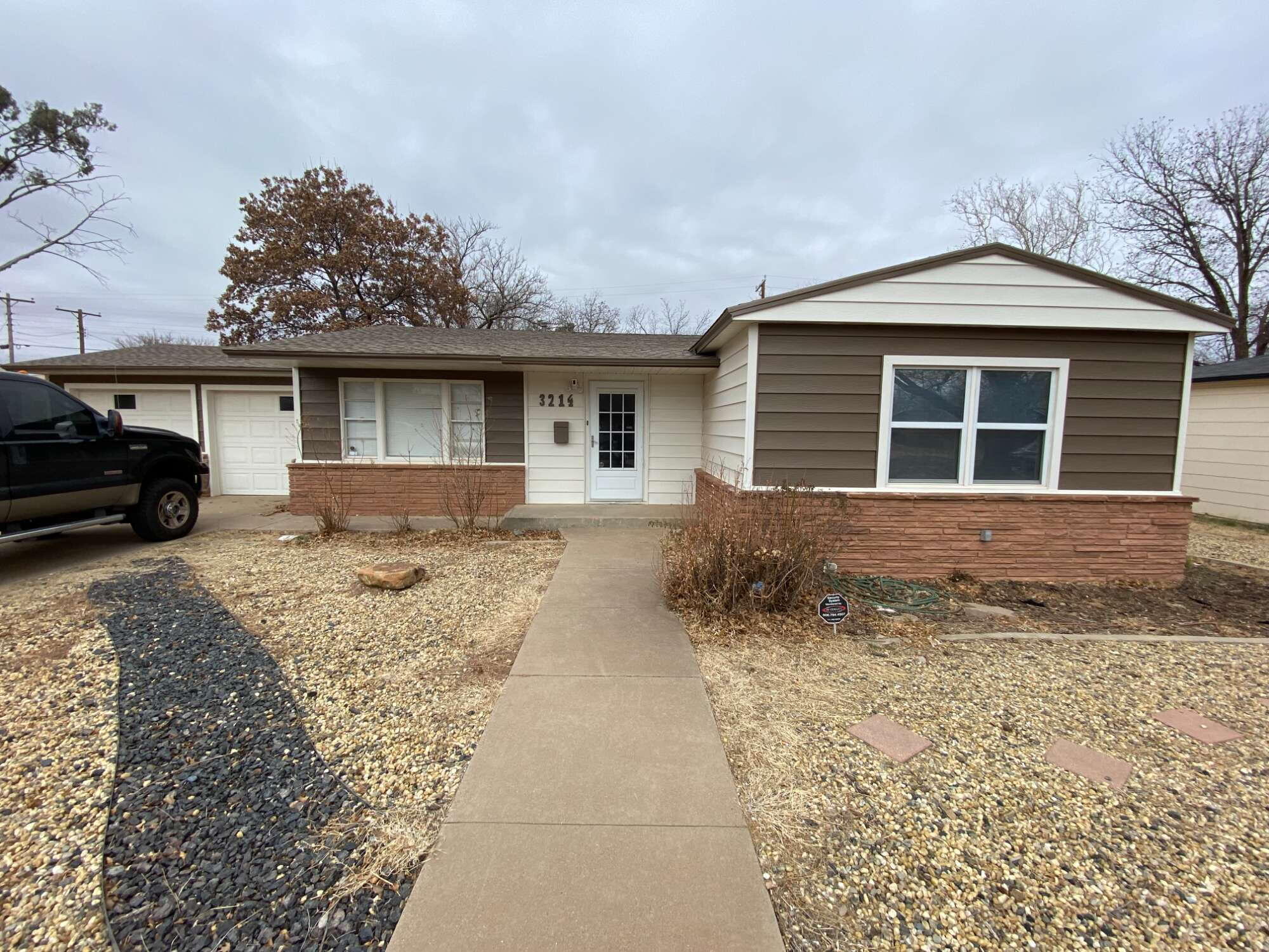 3214 32nd Street Lubbock, TX 79410 - Photo 1 of 17 front view of a house with a yard