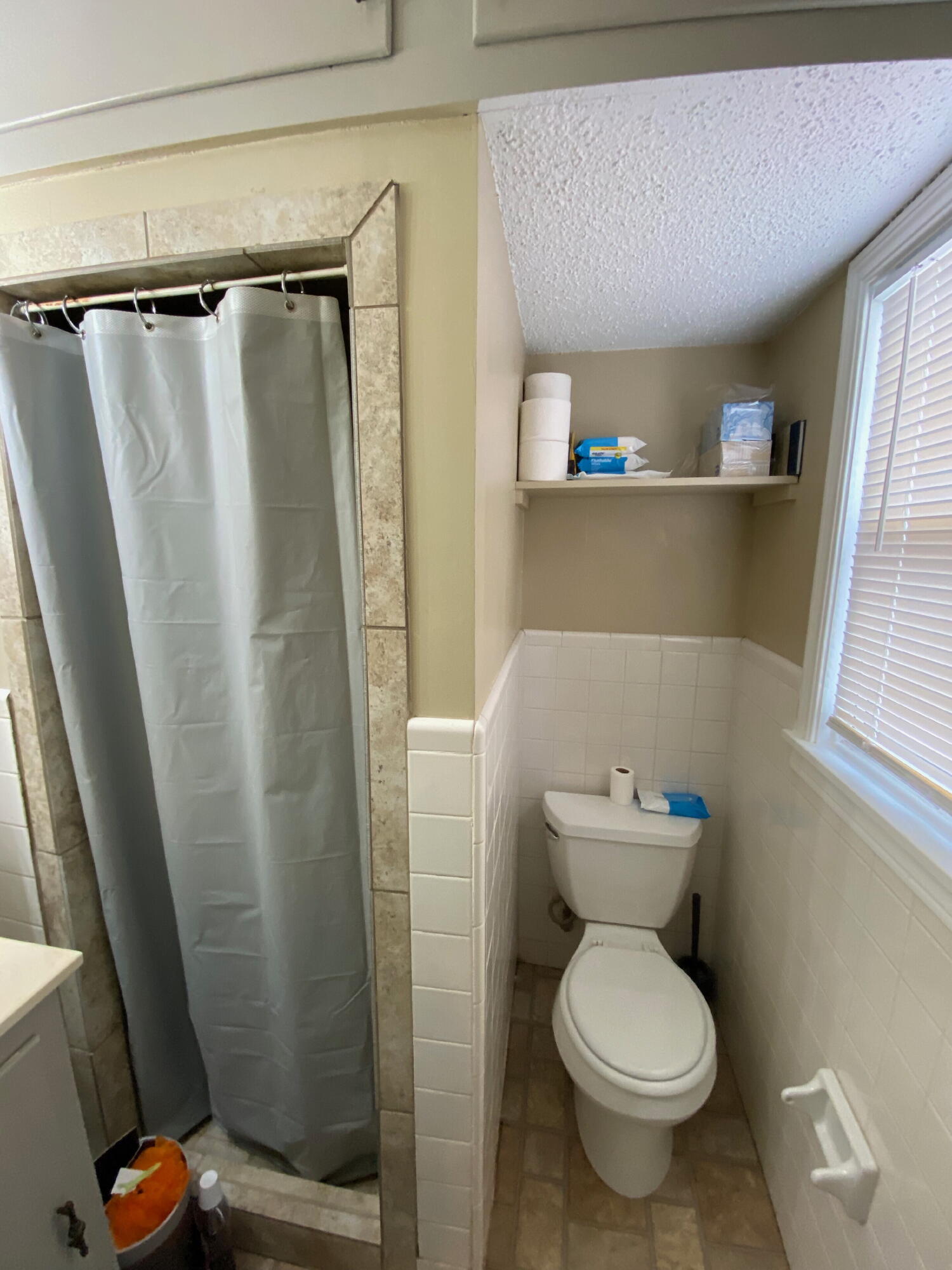 3214 32nd Street Lubbock, TX 79410 - Photo 11 of 17 a bathroom with a toilet and a shower