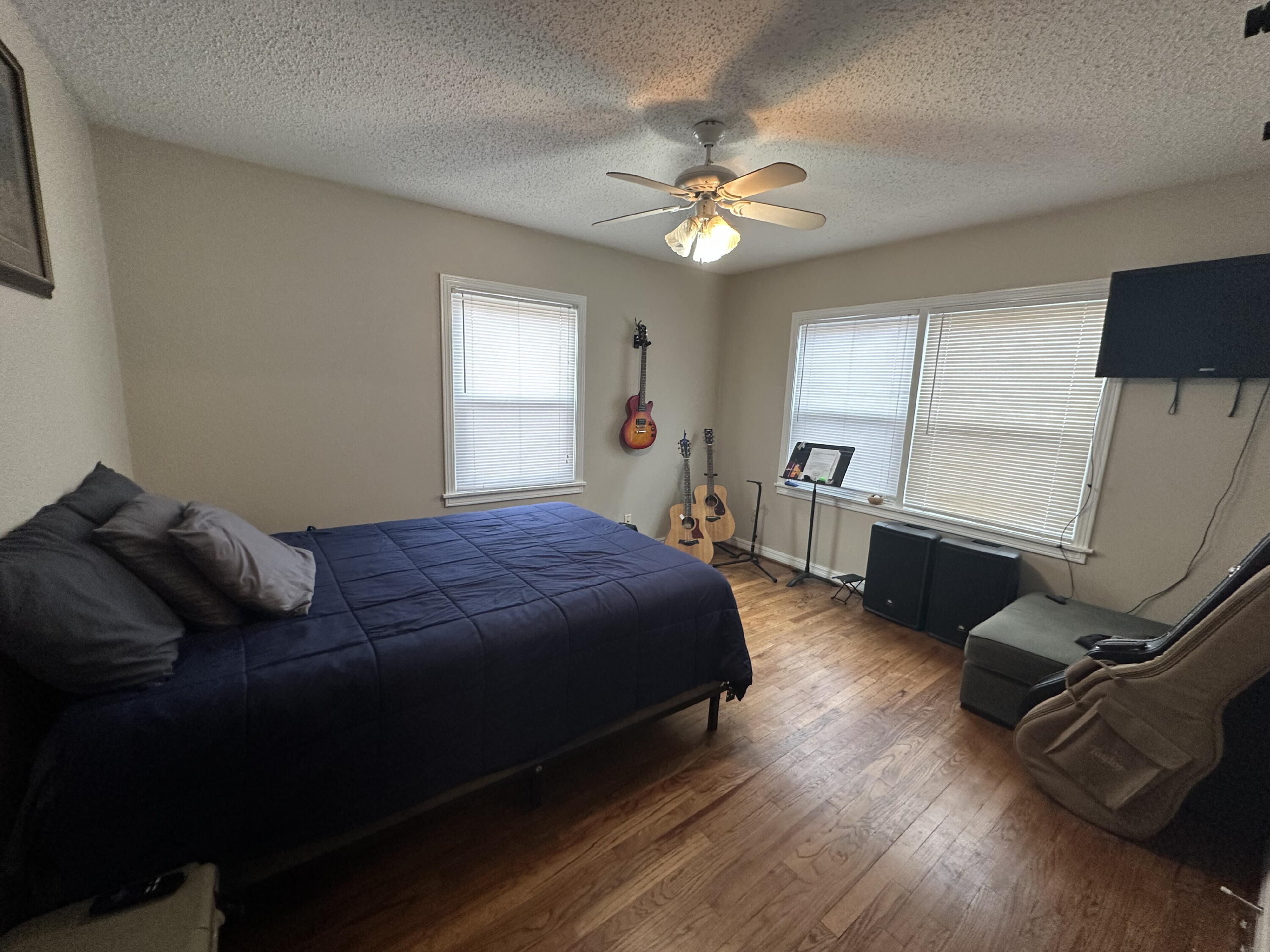3214 32nd Street Lubbock, TX 79410 - Photo 14 of 17 a spacious bedroom with a bed and a chandelier
