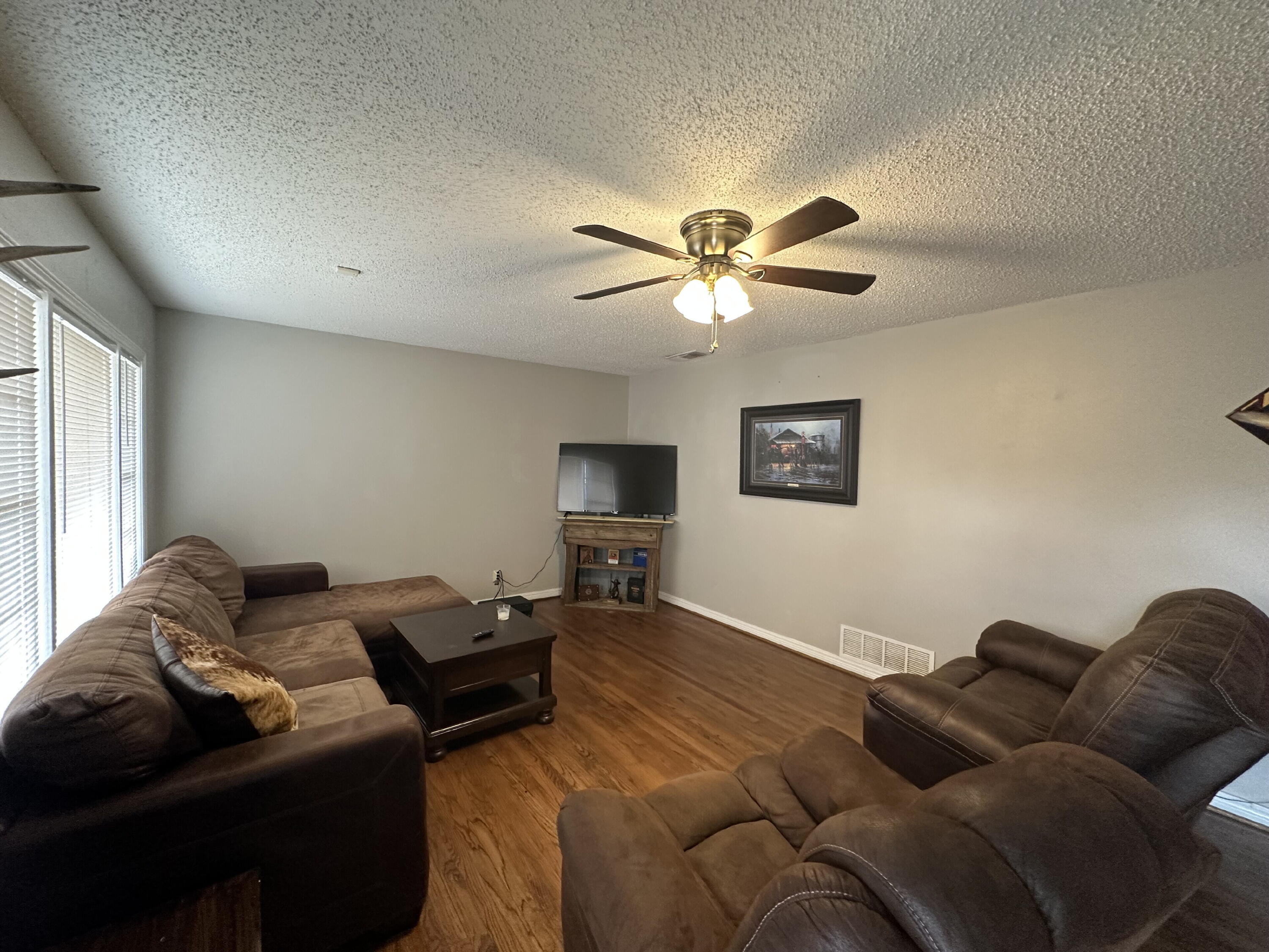 3214 32nd Street Lubbock, TX 79410 - Photo 2 of 17 a living room with furniture ceiling fan and a window
