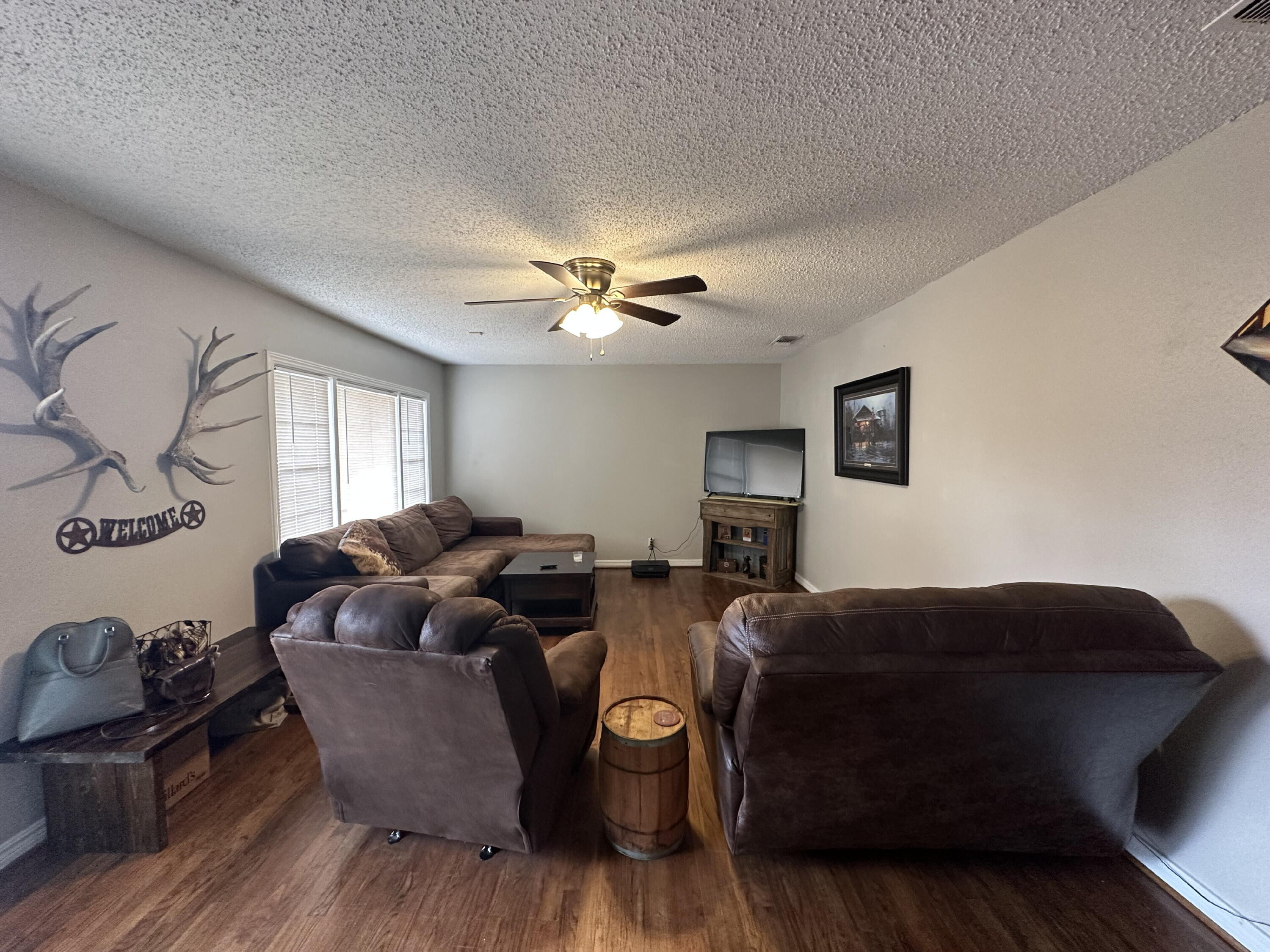 3214 32nd Street Lubbock, TX 79410 - Photo 3 of 17 a living room with furniture and a chandelier