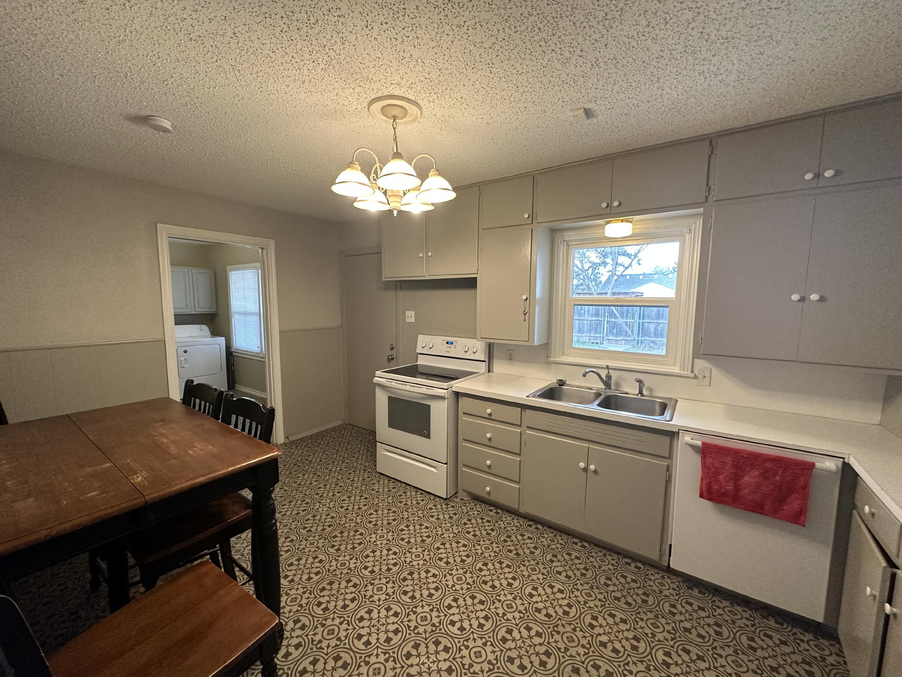 3214 32nd Street Lubbock, TX 79410 - Photo 6 of 17 a large kitchen with a table chairs and a counter top space