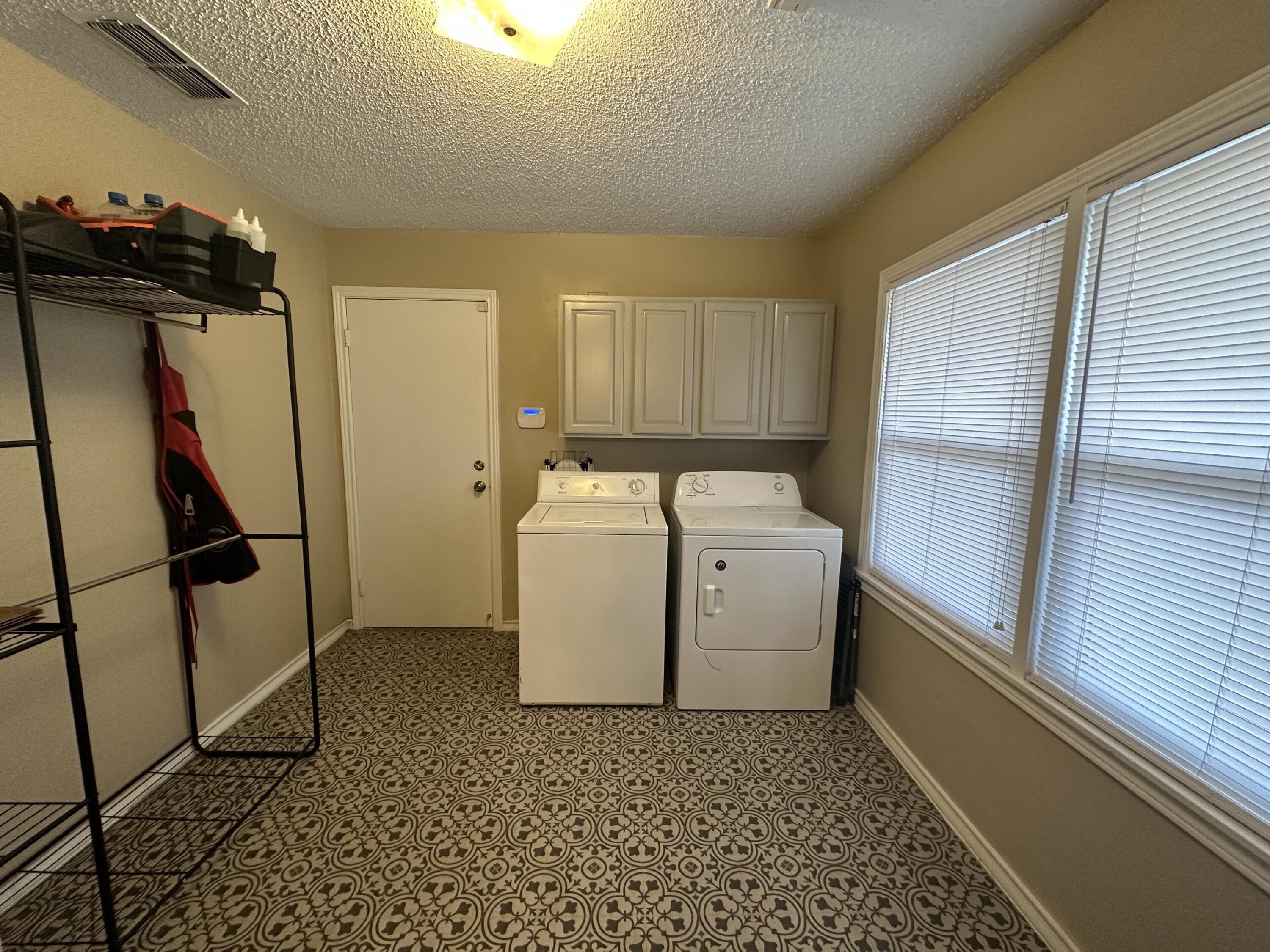 3214 32nd Street Lubbock, TX 79410 - Photo 7 of 17 a utility room with dryer and washer
