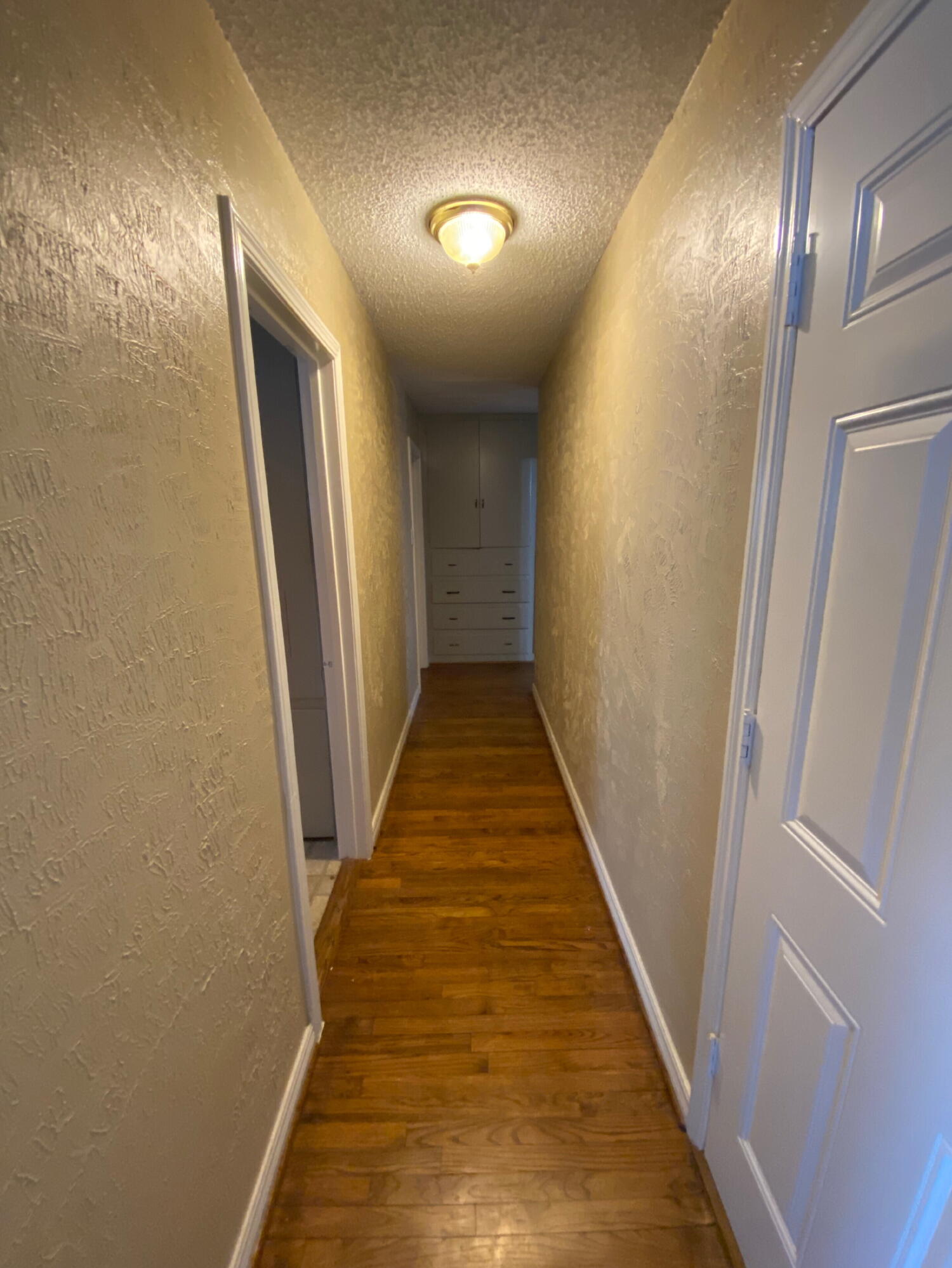 3214 32nd Street Lubbock, TX 79410 - Photo 8 of 17 a view of a hallway with wooden floor