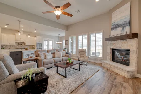 a living room with furniture and a fireplace