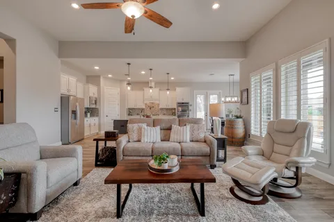 a living room with furniture and a large window