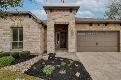 a front view of a house with garage
