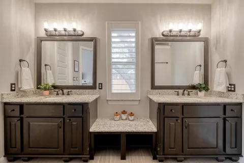 a bathroom with a sink double vanity and a mirror