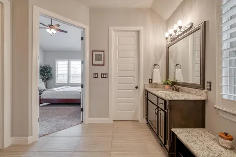 a bathroom with a sink a vanity and a mirror
