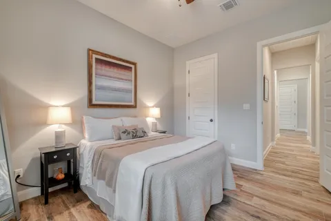 a bedroom with a bed and a painting on the wall