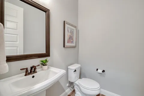 a bathroom with a sink a mirror and a toilet